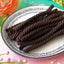 Red Vines Black Licorice Twists candy in a pastel colored spring scene