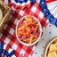 Sour Punch Bites Tropical Flavors on a picnic table with patriotic decorations