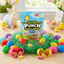 Sour Punch Chicks & Bunnies Easter Candy in a spring setting with toy chicks and bunnies, grassy confetti, and raw candy pieces within plastic Easter eggs
