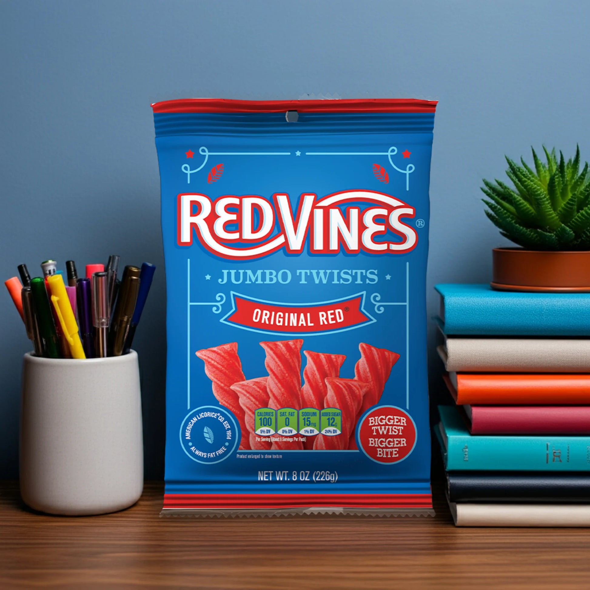 Red Vines Jumbo Twists bag on a desk next to pens and books