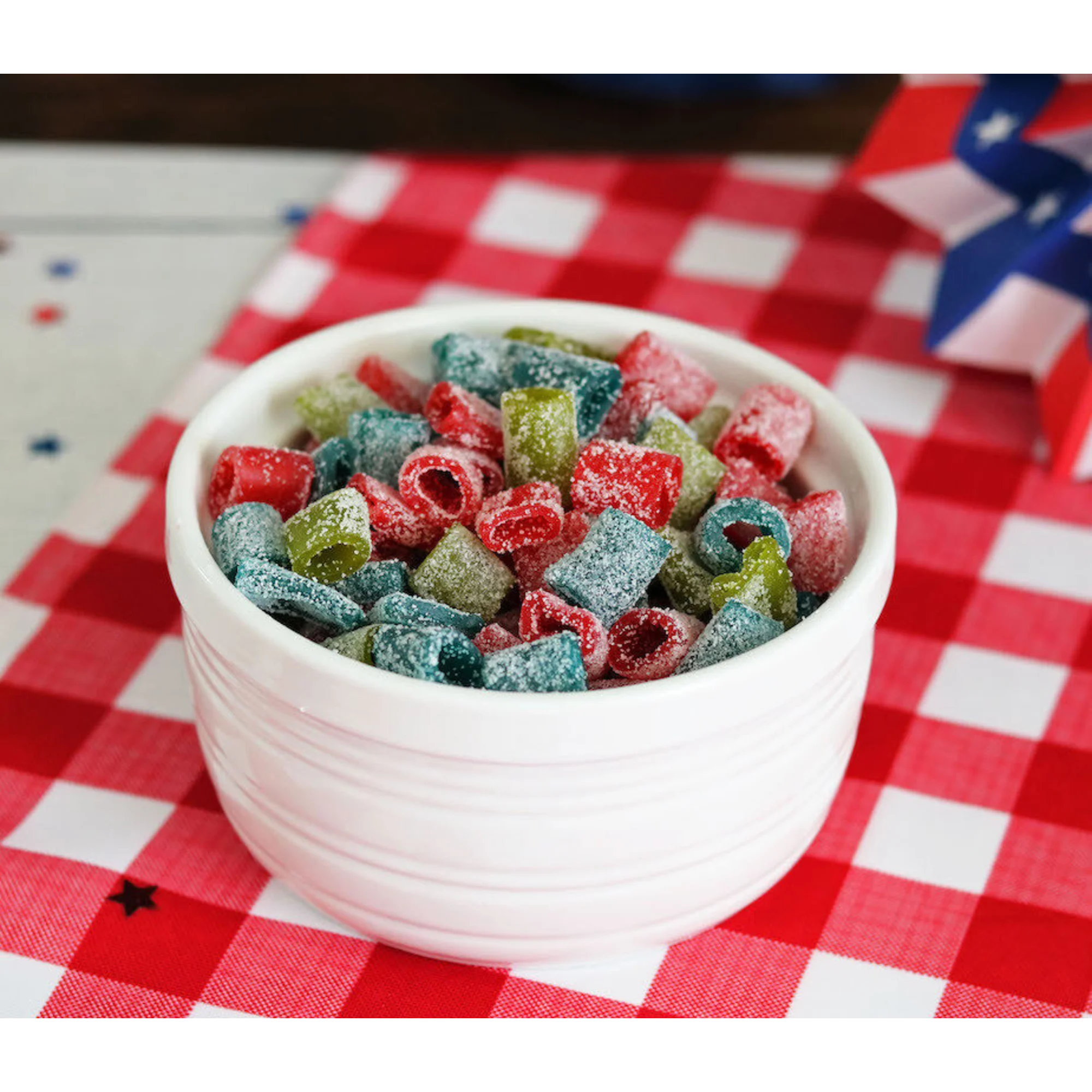 Bowl of Sour Punch Assorted Mini candy on a red and white checkered cloth