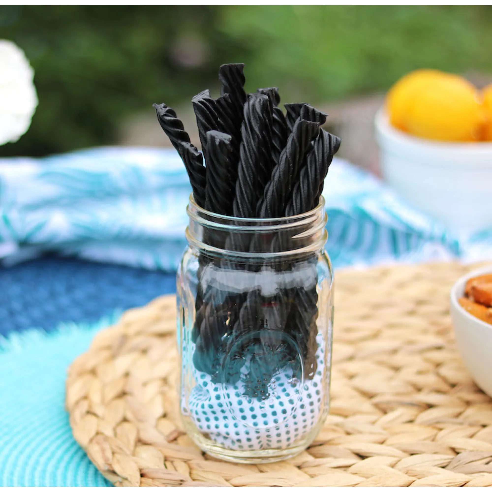 Red Vines Black Sugar Free Licorice Twists in a jar near other poolside snacks