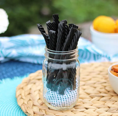 Red Vines Black Sugar Free Licorice Twists in a jar near other poolside snacks
