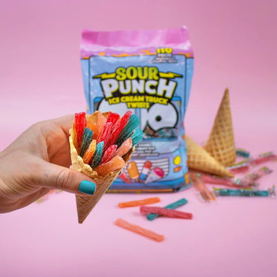 Person holding an ice cream cone full of SOUR PUNCH Ice Cream Truck Twists summer candy