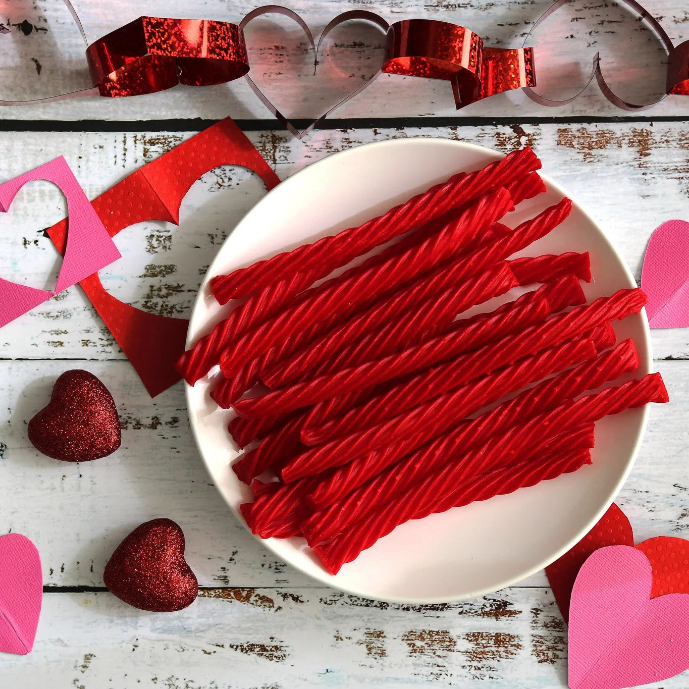 RED VINES Original Red Licorice Twists on a plate surrounded by valentine decor