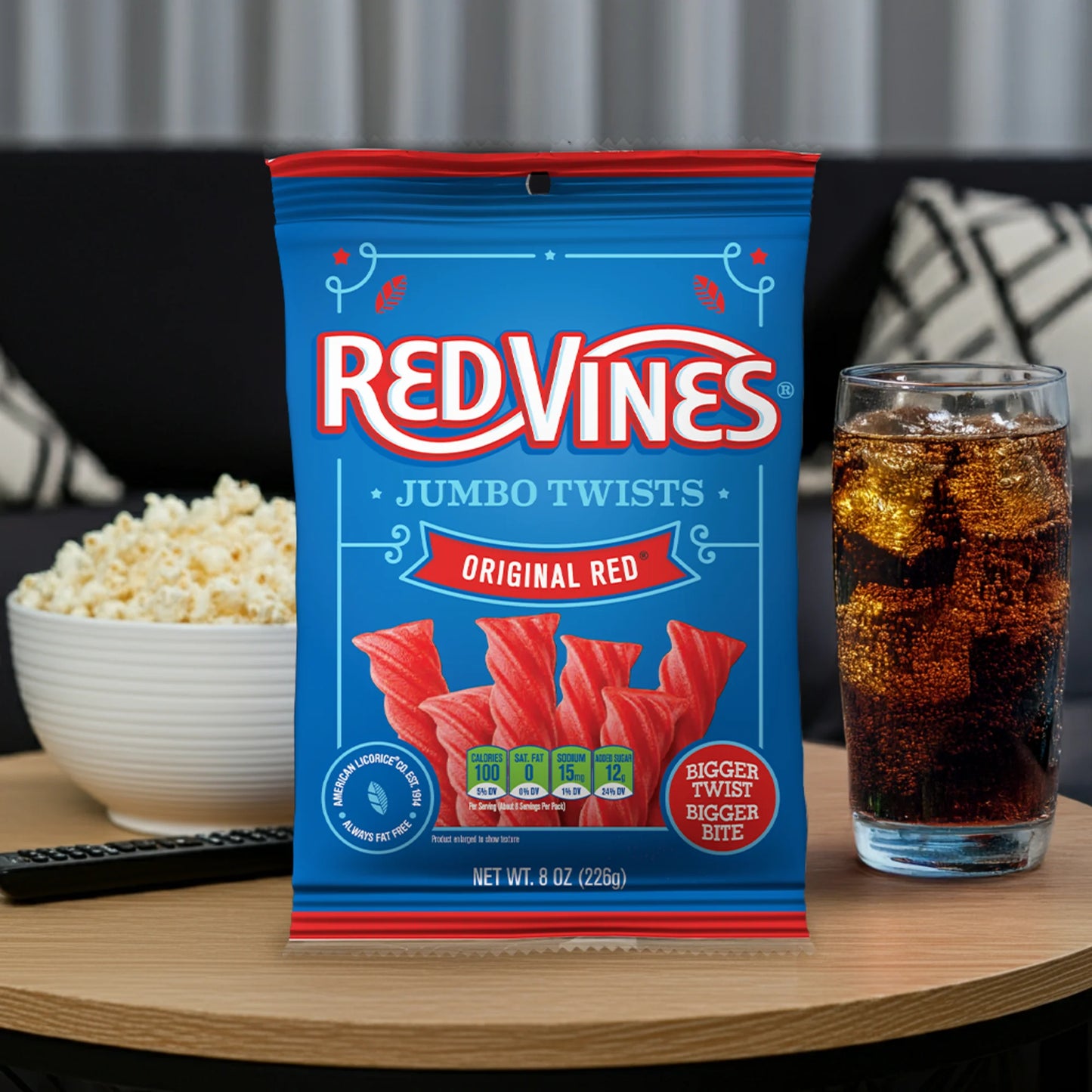 Red Vines Jumbo Twists Bag on a coffee table with popcorn and soda