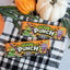 SOUR PUNCH Spooky Straws Halloween Candy trays alongside pumpkins