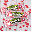 SOUR PUNCH Cupid Straws valentine candy trays on white table with red cut out hearts