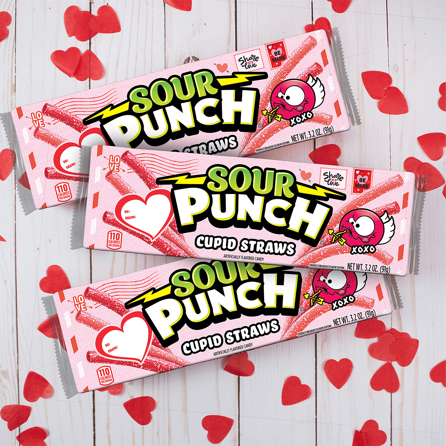 SOUR PUNCH Cupid Straws valentine candy trays on white table with red cut out hearts