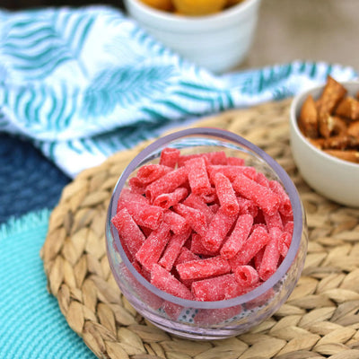 Sour Punch Strawberry Bites in a bowl near other poolside snacks
