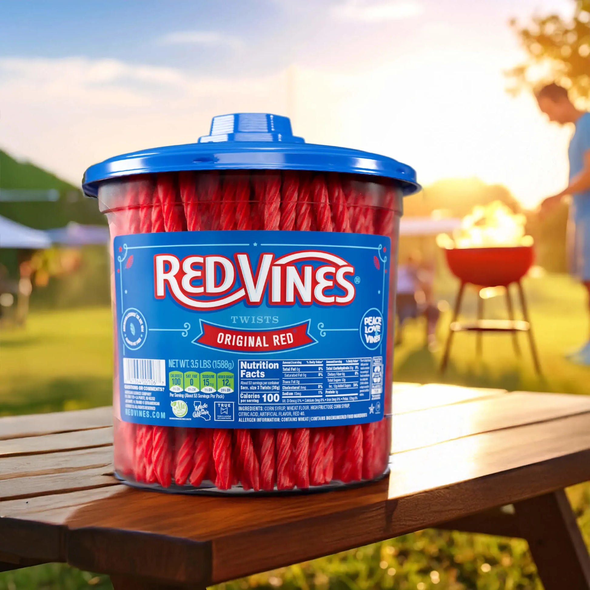Red Vines Jar on a picnic table with a man grilling in the background 