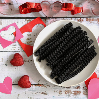 RED VINES Black Licorice Twists on a white plate surrounded by valentine decor