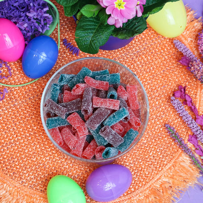 Sour Punch Sweet Bites candy in a dish surrounded by plastic Easter eggs