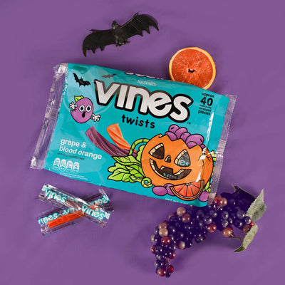 Vines Individually Wrapped Halloween Candy Twists 9oz bag on a purple background with bats and fall fruits