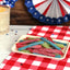 Sour Punch Twists, 3" Individually Wrapped Candy, Assorted Flavors, on a picnic table with patriotic decorations