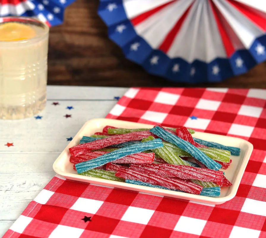 Sour Punch Twists, 3" Individually Wrapped Candy, Assorted Flavors, on a picnic table with patriotic decorations