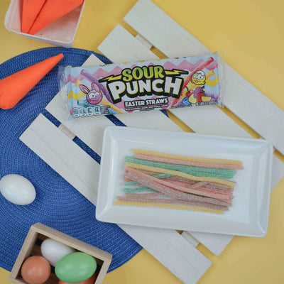 SOUR PUNCH Easter Candy Straws on a snack platter surrounded by dyed Easter eggs