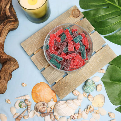 Sour Punch Sweet Bites candy in a summer scene with seashells and beach wood