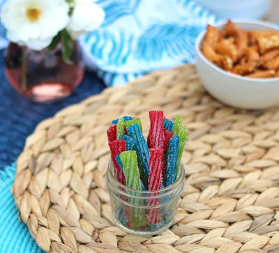 Sour Punch Twists, 3" Individually Wrapped Candy, Assorted Flavors, in a jar near other poolside snacks