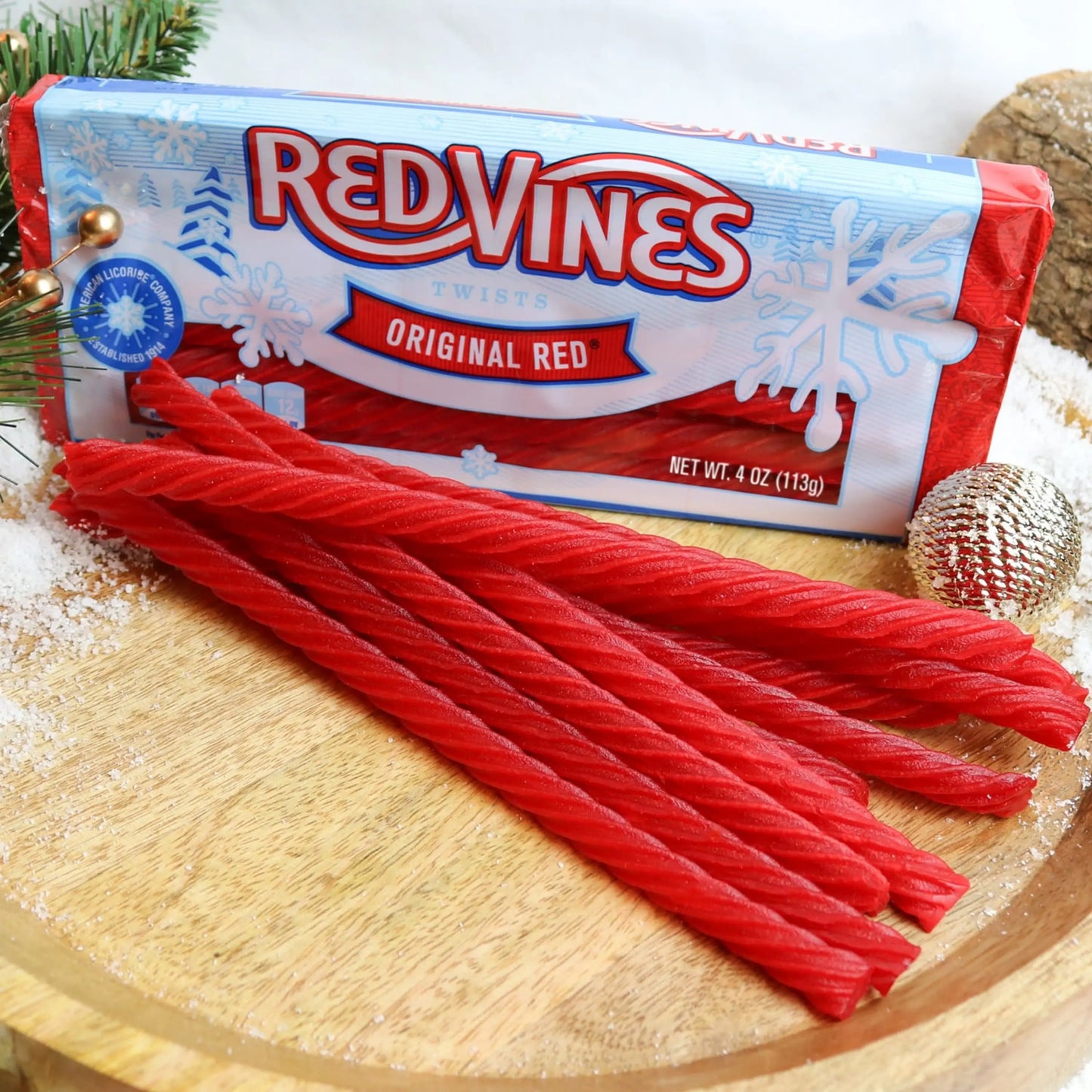RED VINES Original Red Licorice Twists in winter seasonal tray with candy in front on a festive platter