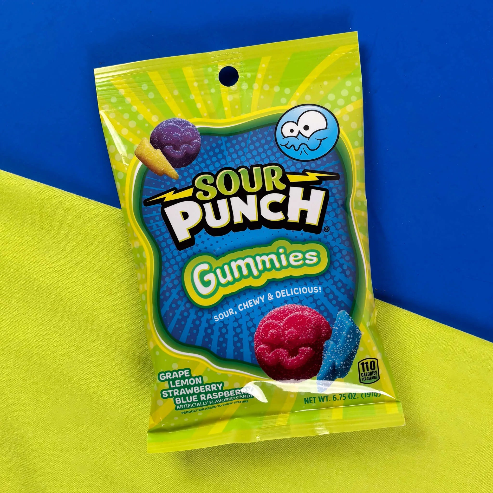 Sour Punch Gummies 6.75oz bag on a split yellow and blue background