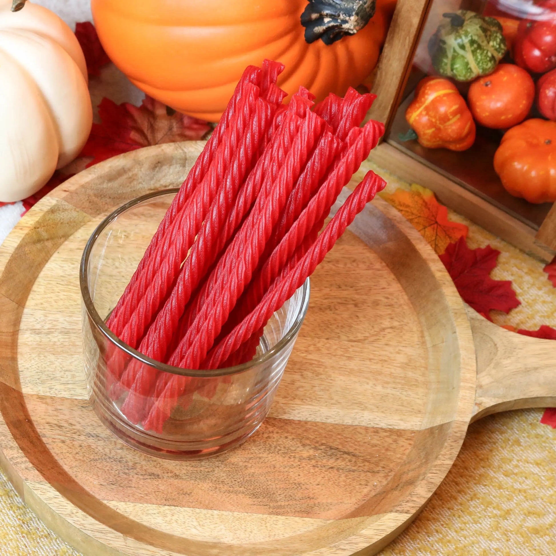 Red Vines Original Red Licorice Candy in a candy dish surrounded by pumpkins and leaves