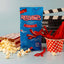 Red Vines Original Red Twisted Vines Candy 4oz Bag with a tub of popcorn and a cup of twisted red licorice candy pieces