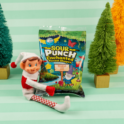 Elf hugging a bag of Sour Punch Enchanted Forest Shapes