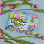 SOUR PUNCH Easter Candy Twists on a pastel blue background surrounded by spring flowers