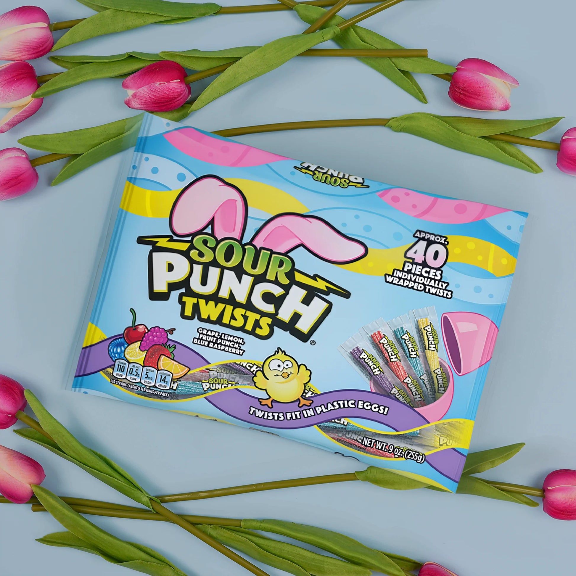 SOUR PUNCH Easter Candy Twists on a pastel blue background surrounded by spring flowers