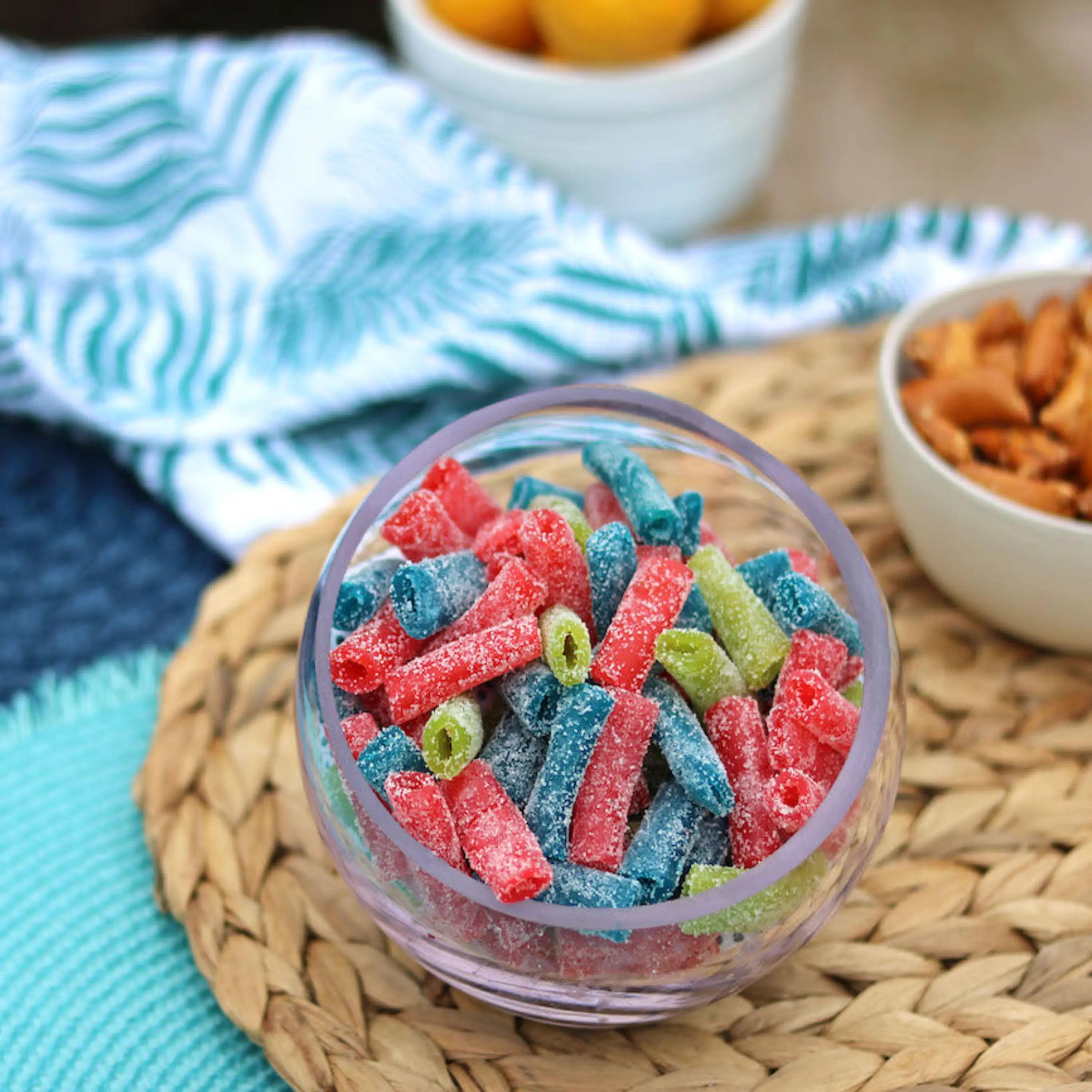 Sour Punch Bites Candy Assorted Flavors in a bowl near other poolside snacks