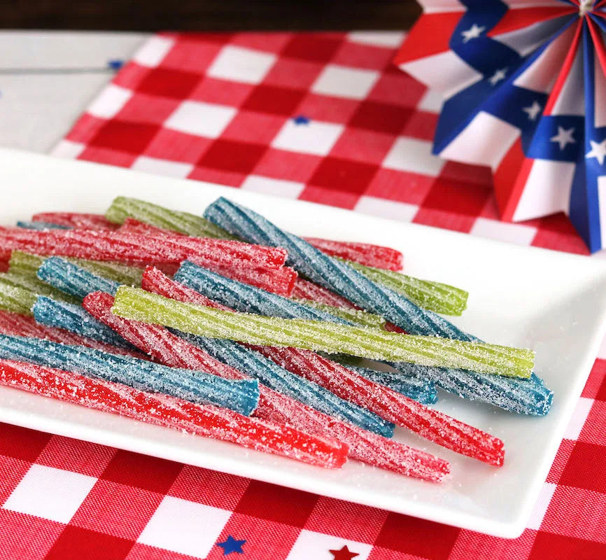 Sour Punch Twists, 6" Individually Wrapped Candy, Assorted Flavors, on a picnic table with patriotic decorations
