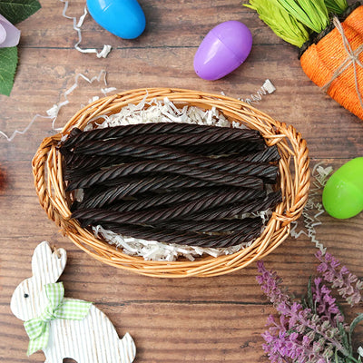 Red Vines Black Licorice Twists candy in an Easter basket  surrounded by confetti and plastic eggs