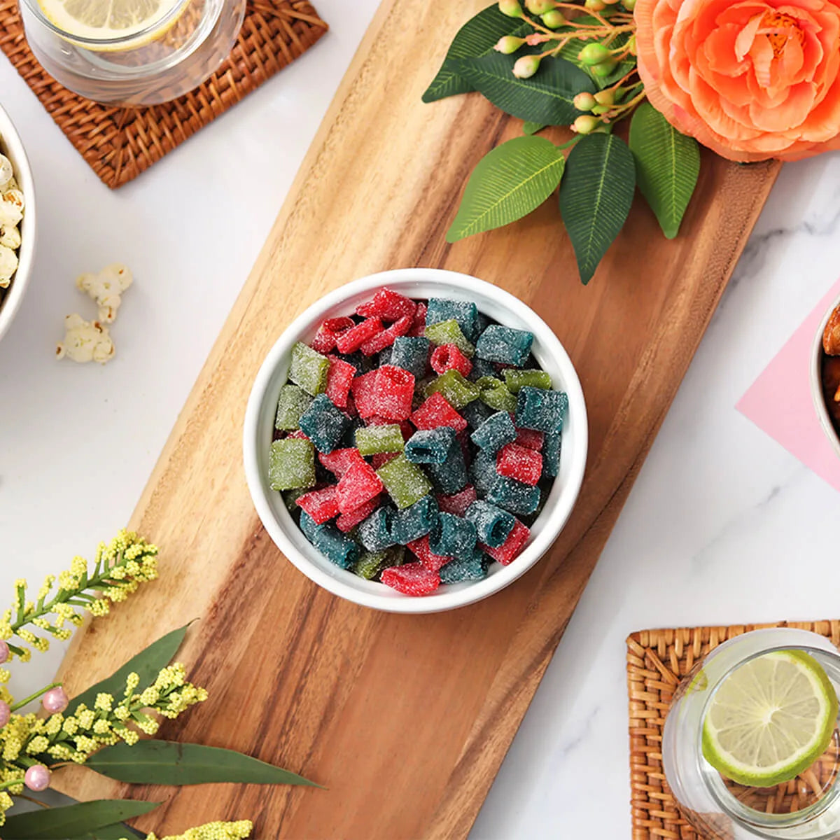 Bowl of Sour Punch Assorted Mini candy as a center piece with roses