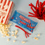 Red Vines Original Red Twisted Vines 2.5oz Bag with a tub of popcorn and raw peelable licorice pieces