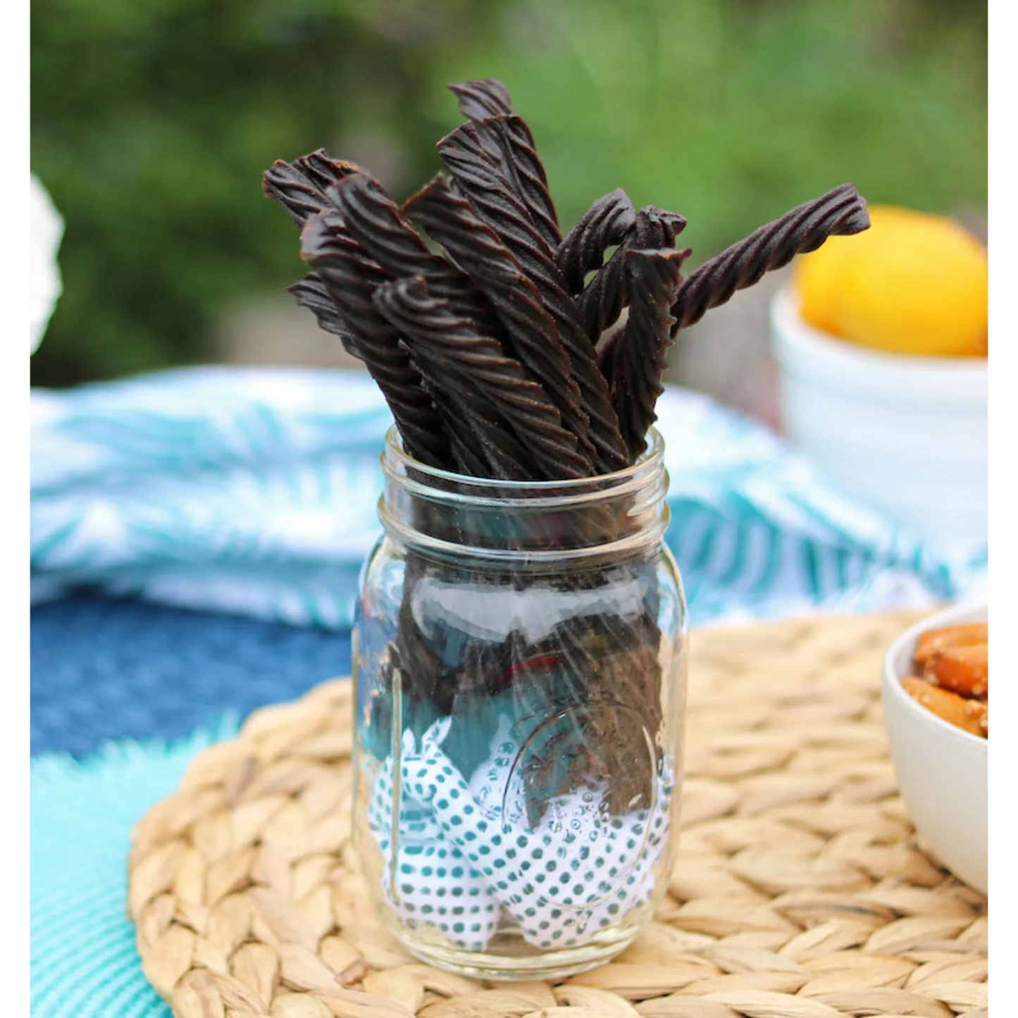 Red Vines Black Licorice Candy Twists in a jar near other poolside snacks