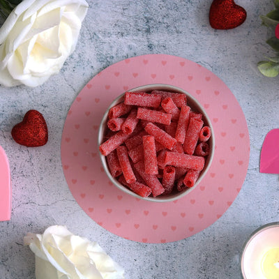 SOUR PUNCH Strawberry Candy Bites in a bowl surrounded by roses and hearts