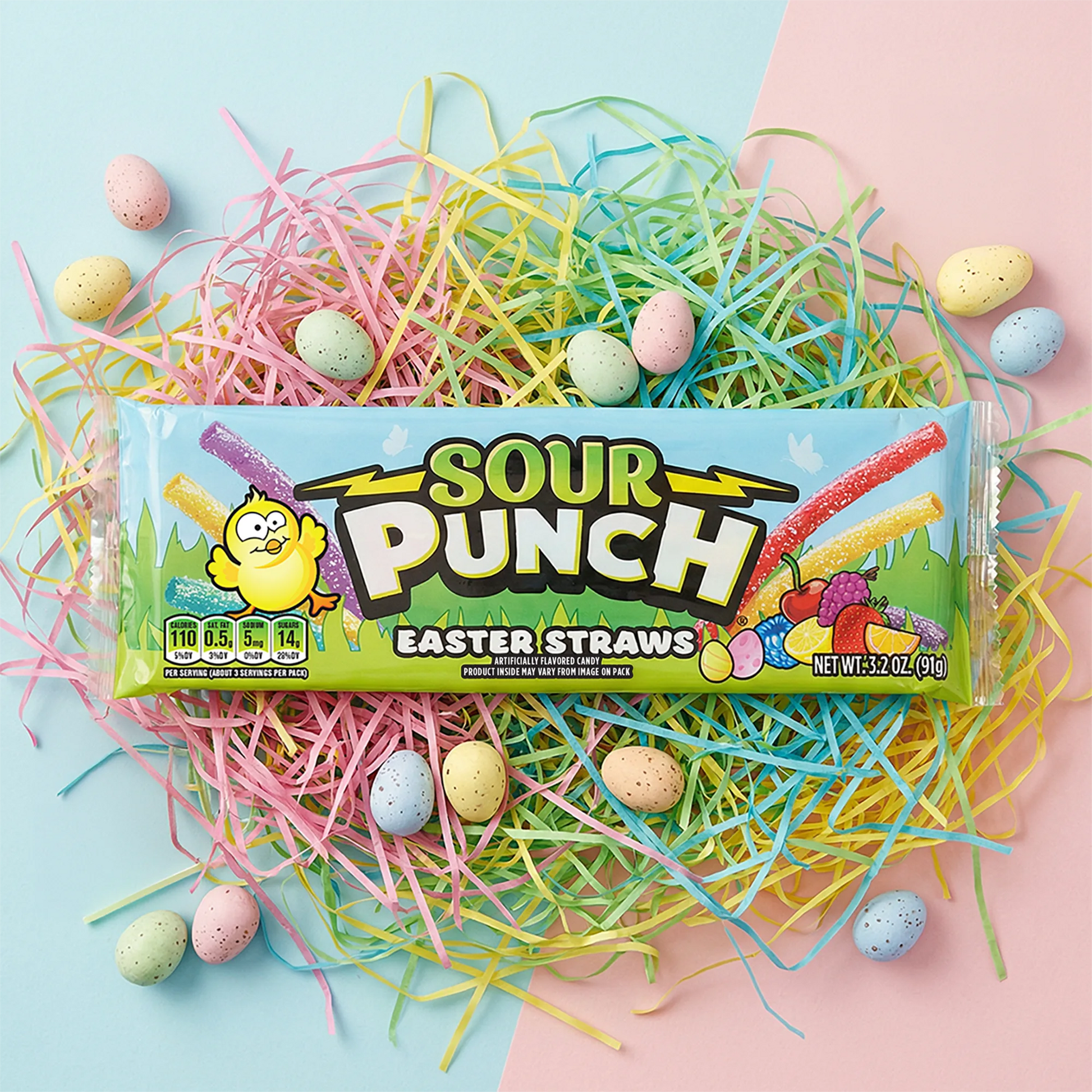 Sour Punch Easter Straws on a pile of colorful confetti, surrounded by pastel dyed Easter eggs