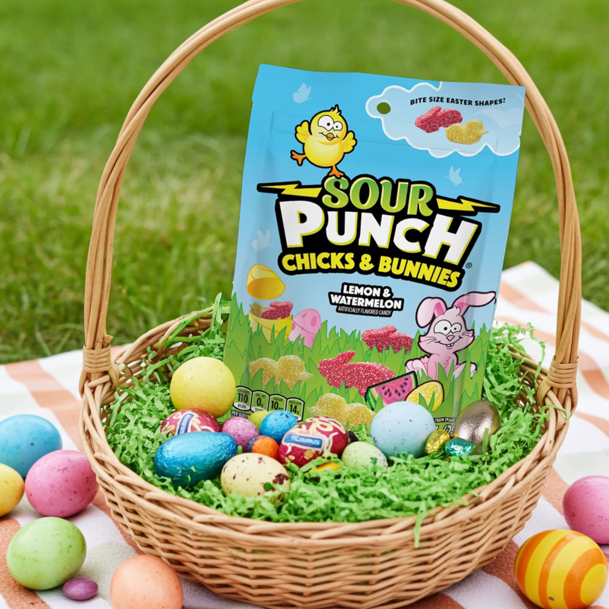 Bag of Sour Punch Chicks & Bunnies Easter Candy outdoors in an Easter basket with other goodies