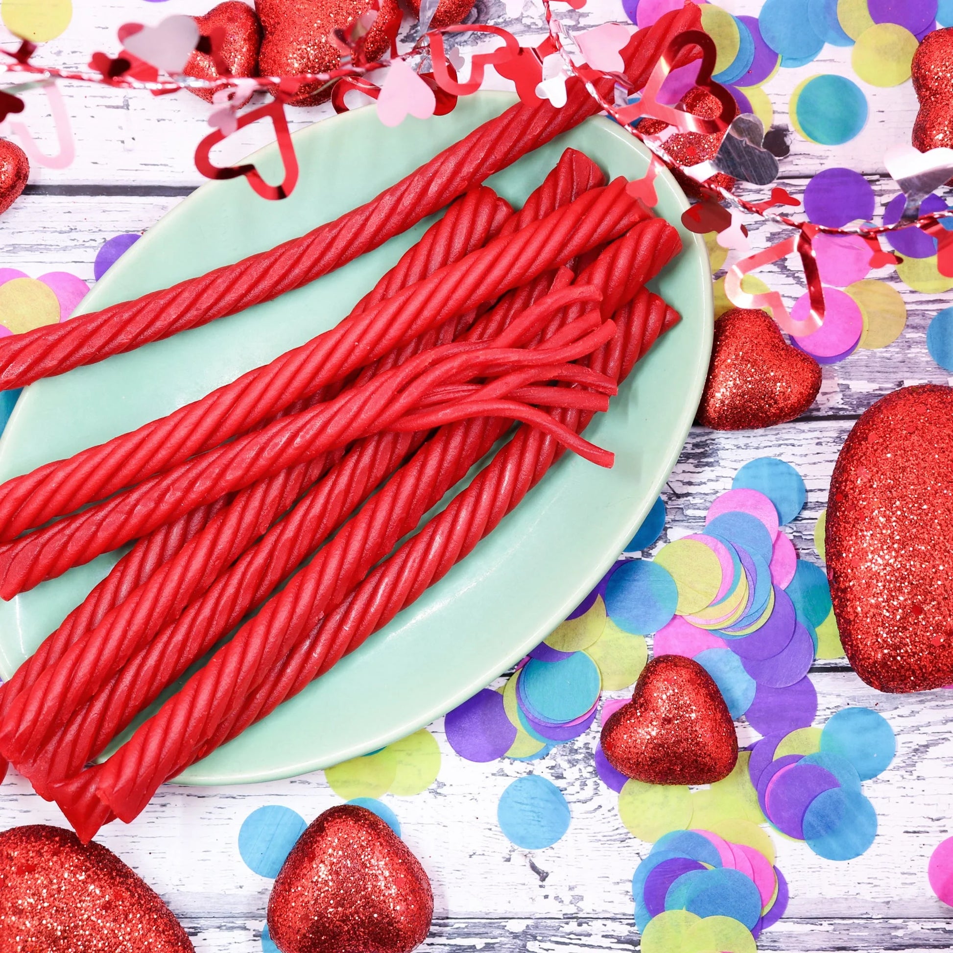 RED VINES SuperStrings Licorice on a platter surrounded by colorful valentine decor