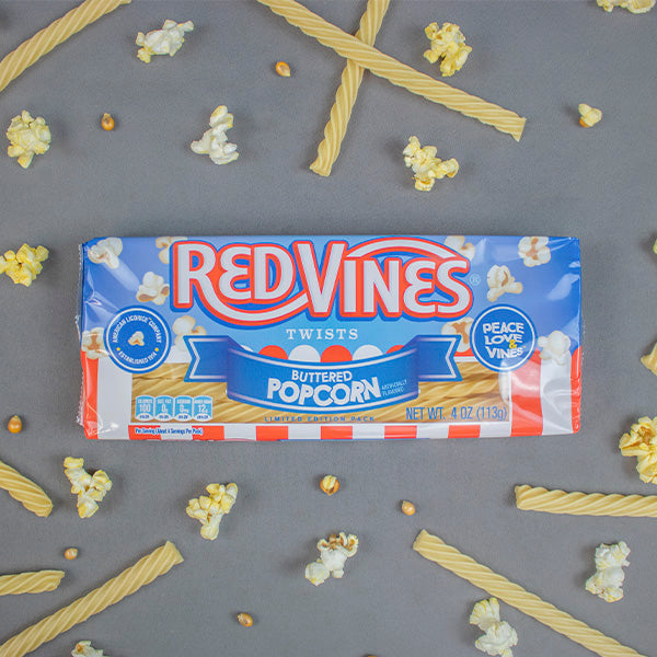 RED VINES Buttered Popcorn Twists Popcorn Candy Tray on gray background with real popcorn