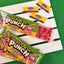 Open Sour Punch Tray with Chamoy Sauce drizzled over Watermelon candy straws