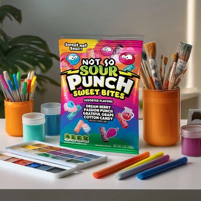 Bag of Sour Punch Sweet Bites surrounded by art supplies on a desk