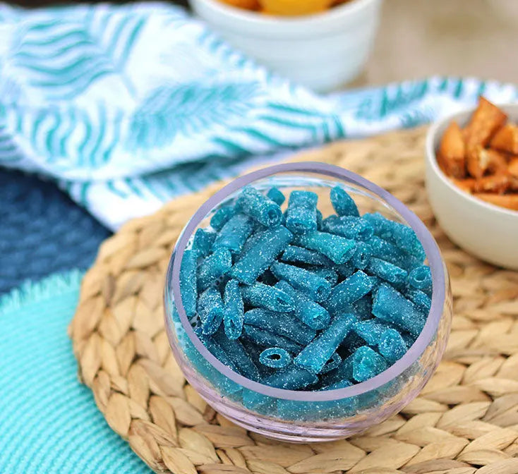 Sour Punch Bites Blue Raspberry Candy in a bowl near other poolside snacks
