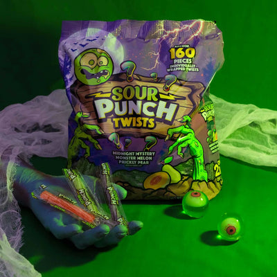 Sour Punch Individually Wrapped Halloween Candy Twists 35oz bag in a spooky scene with monster hand and eyeballs