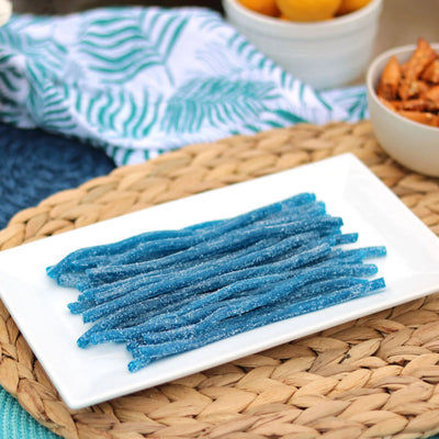 Sour Punch Blue Raspberry Straws Candy on a platter near other poolside snacks