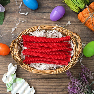 Red Vines Sugar Free Strawberry Licorice Twists in an Easter basket  surrounded by confetti and plastic eggs