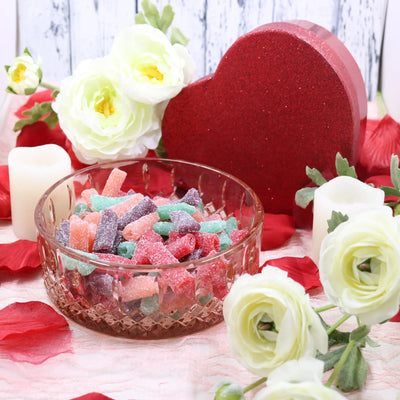 SOUR PUNCH Sweet Bites candy in a glass dish surrounded by roses and red sparkle hearts