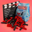 Red Vines Classic Mix Minis Bag next to a film clapperboard with mini black and red licorice in front