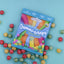 Cylindrical shaped red, yellow, and green candy scattered around a Torie & Howard Gummi-Snaps Tropical Flavors Bag